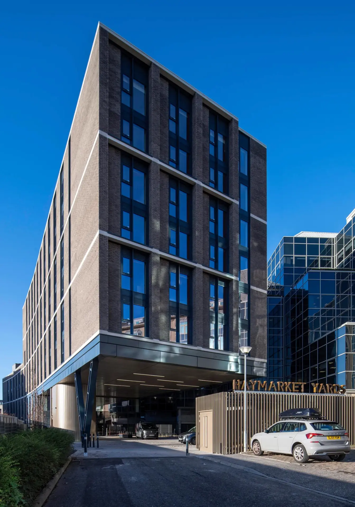 Completed development at 22 Haymarket Yards, Edinburgh, showing the brick and glazed elevation with the Haymarket Yards signage at entrance level