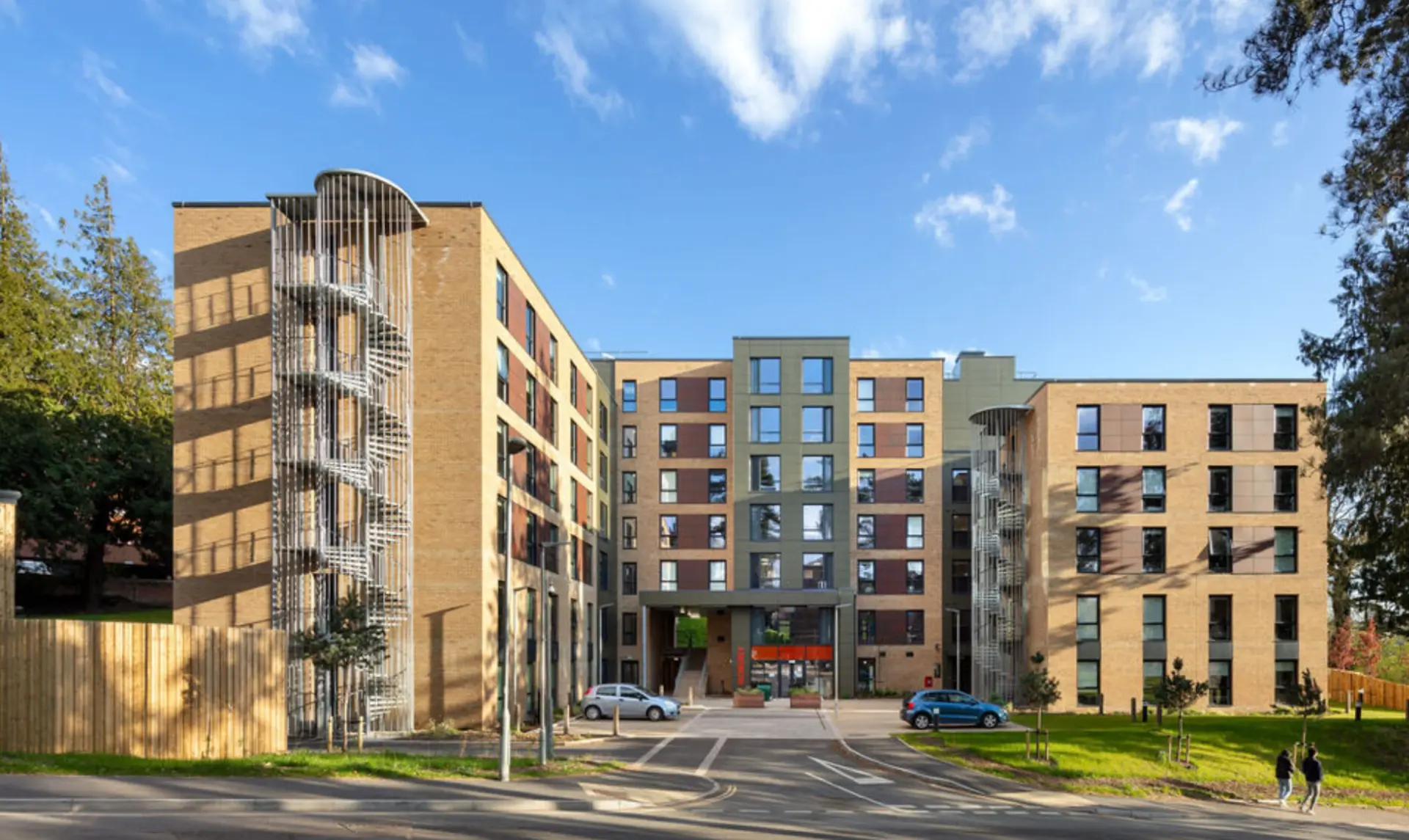 The Moberly Building student accommodation at the University of Exeter, showing brick elevations, external spiral stair cores and the main entrance