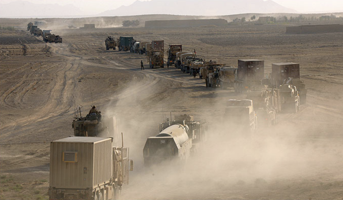 Military logistics convoy transporting Walker Modular bathroom pods across desert terrain